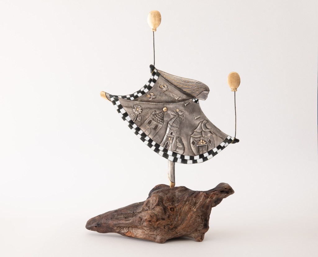 Girl with a magic dress. Embossed pewter 350 x 260mm by artist Sandy Griffiths.