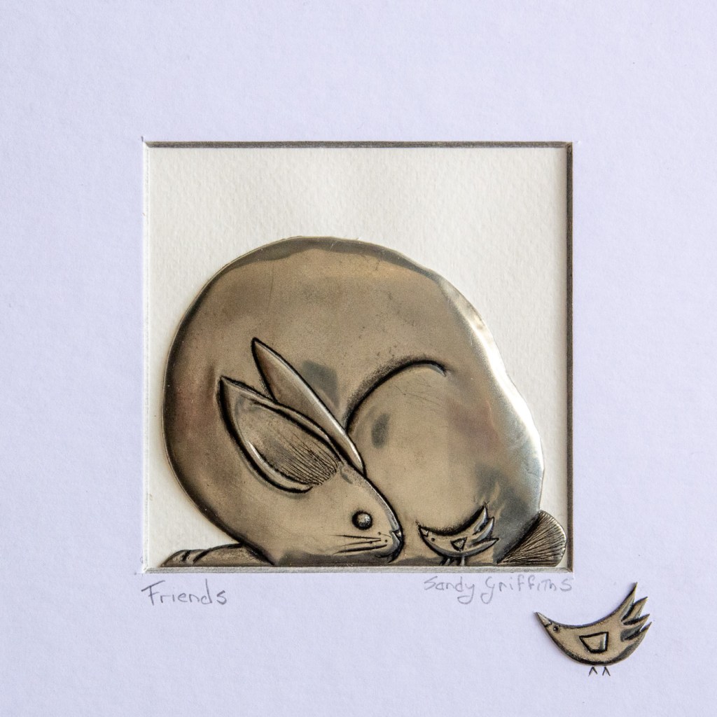 Hand-embossed pewter rabbit with bird friends in a black box frame, by Sandy Griffiths. 230 x 230mm.